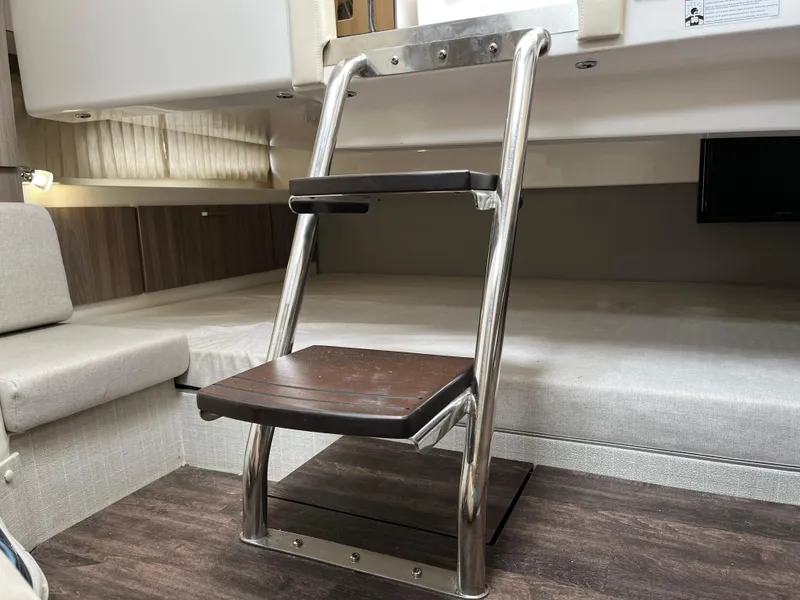 Slide: The Image of Interior of 2022 Regal 33 SAV boat with metal and wood ladder. - 28
