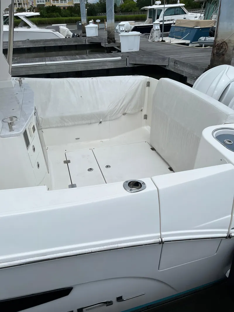 Slide: The Image of 2022 Regal 33 SAV boat docked, featuring a spacious white deck area. - 3