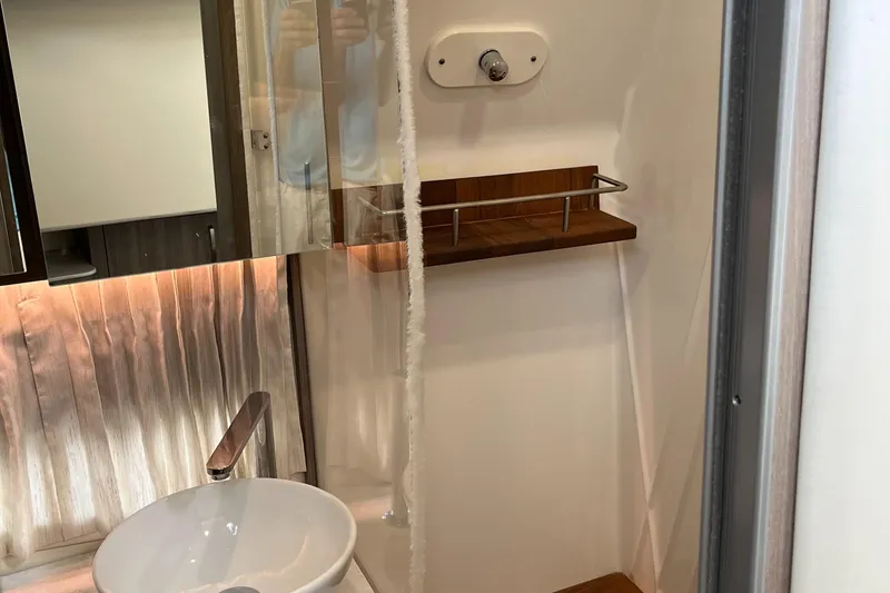 Slide: The Image of Modern bathroom interior in 2022 Regal 33 SAV boat, featuring sleek sink and wooden accents. - 30