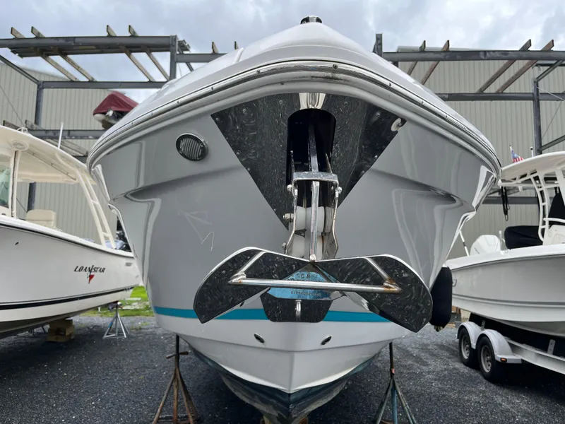 Slide: The Image of 2022 Regal 33 SAV boat front view, displayed outdoors with other boats. - 38