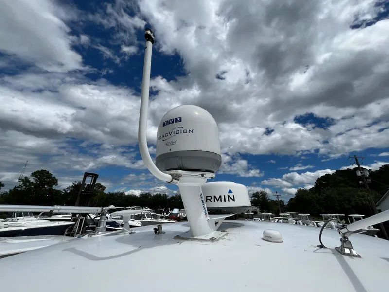 Slide: The Image of 2022 Regal 33 SAV boat with radar and navigation equipment under a cloudy sky. - 40