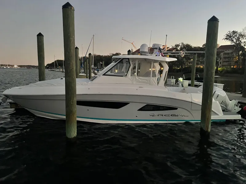 Slide: The Image of 2022 Regal 33 SAV boat docked at a marina during sunset. - 41