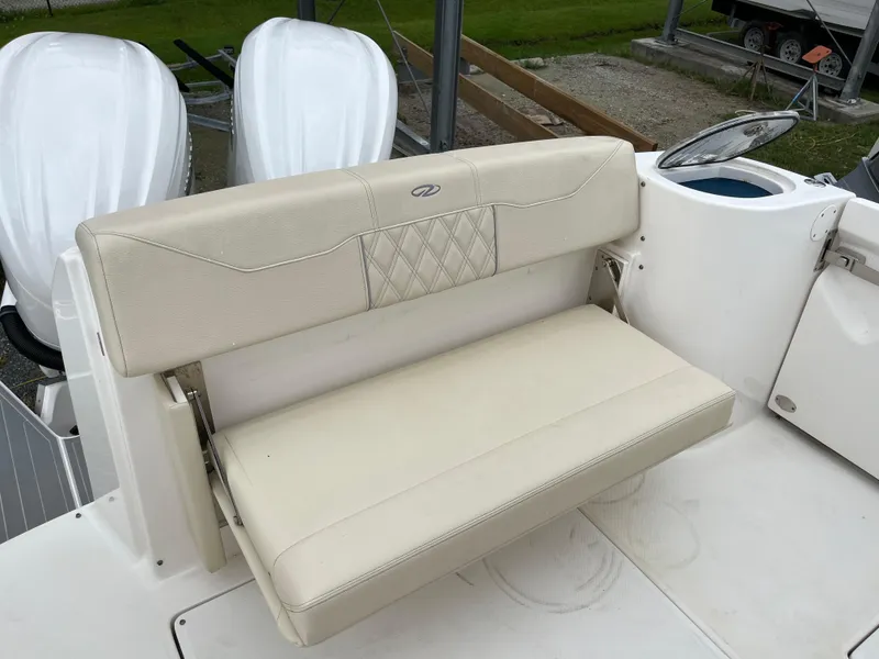 Slide: The Image of 2022 Regal 33 SAV boat with beige leather seating and dual outboard motors. - 5