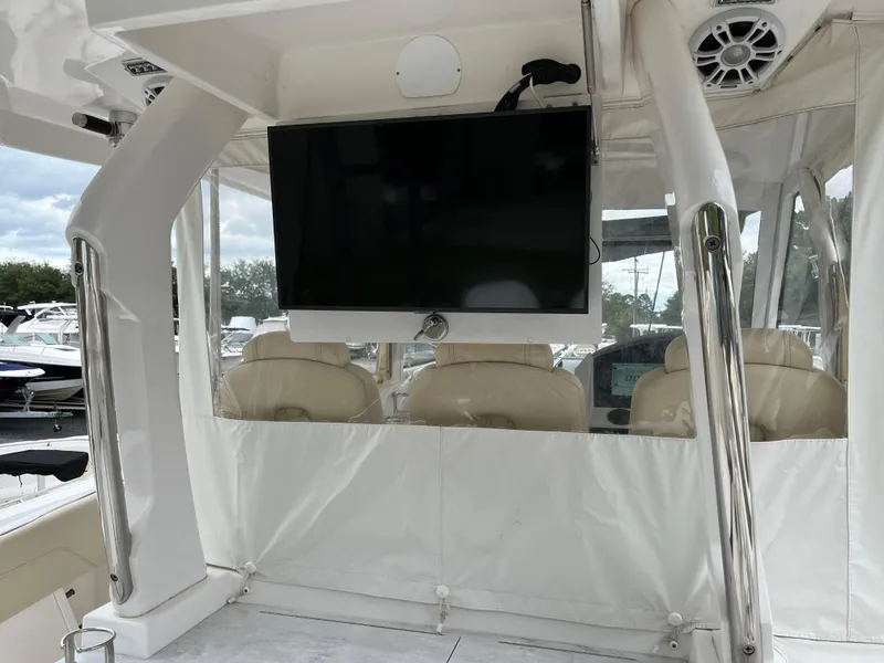 Slide: The Image of 2022 Regal 33 SAV boat interior with TV and seating area. - 8