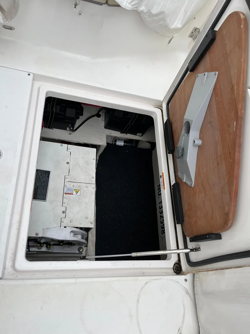 Slide: The Image of Open hatch of 2022 Regal 33 SAV boat, revealing interior compartment. - 9