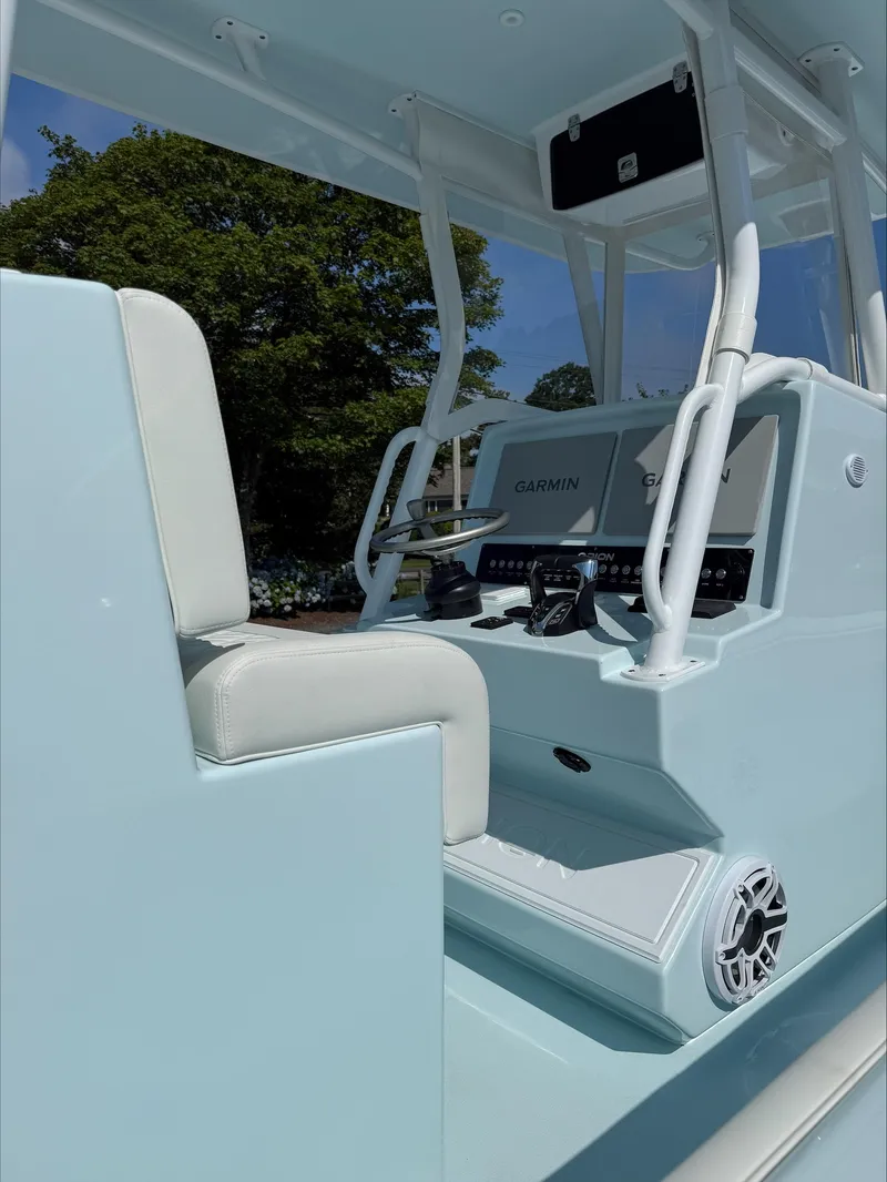 Slide: The Image of 2025 Orion 29 CC boat interior with Garmin navigation system and white seating. - 3