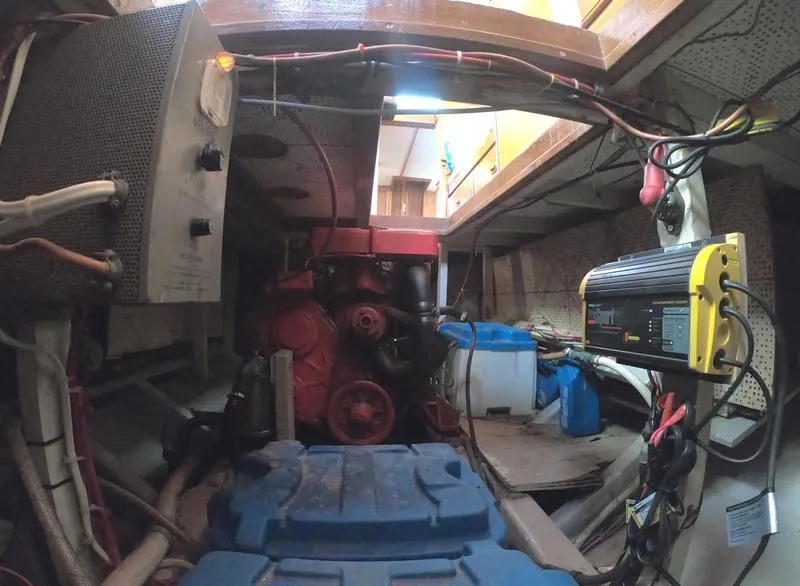 Slide: The Image of 1977 CHB 34 engine room with red engine and electrical components. - 19