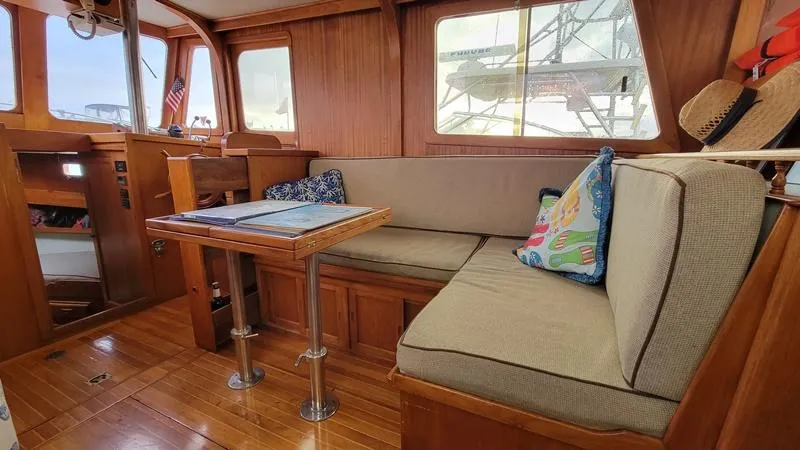 Slide: The Image of Interior of a 1977 CHB 34 boat with wooden furnishings and cozy seating area. - 25