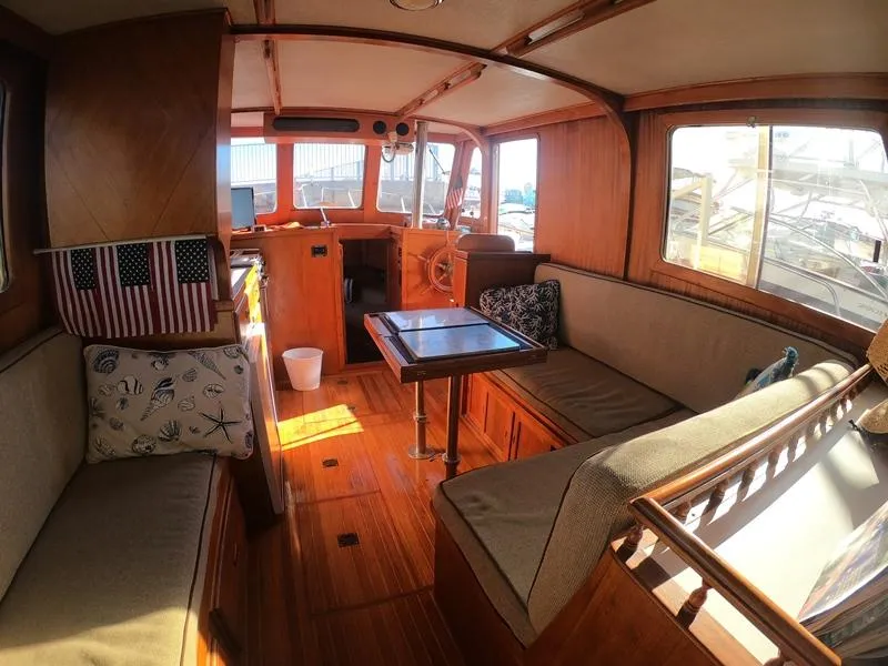 Slide: The Image of 1977 CHB 34 boat interior with wooden furnishings and seating area. - 28