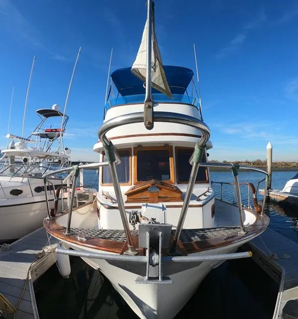 Slide: The Image of 1977 CHB 34 yacht docked at marina under clear blue sky. - 3
