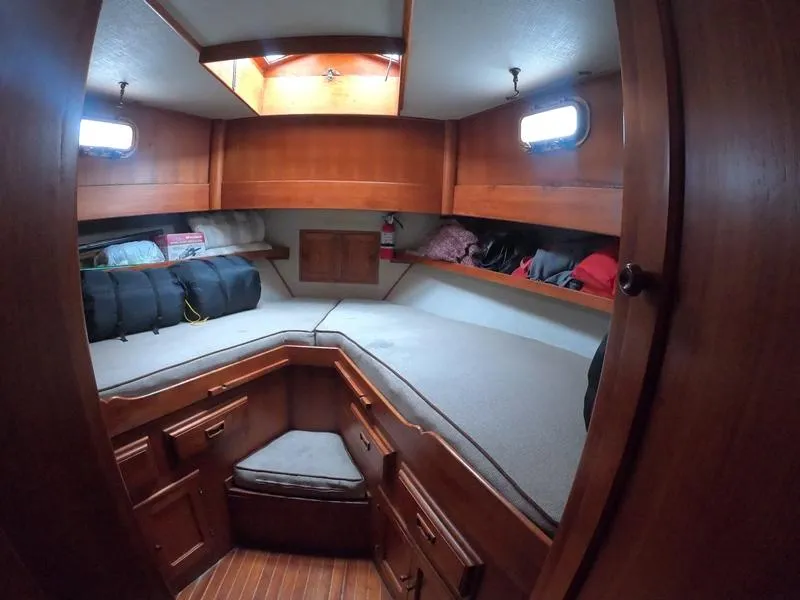 Slide: The Image of 1977 CHB 34 boat cabin with wooden interior and storage compartments. - 33