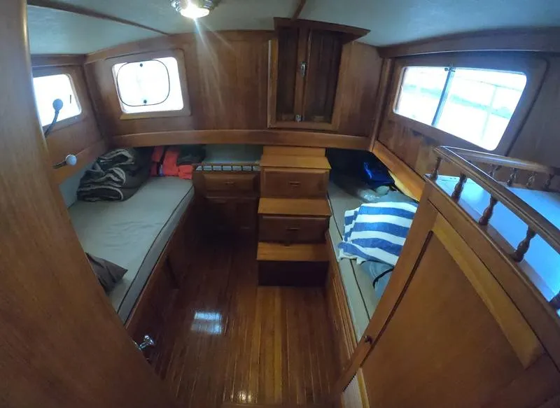 Slide: The Image of 1977 CHB 34 boat interior with wooden furnishings and twin beds. - 34