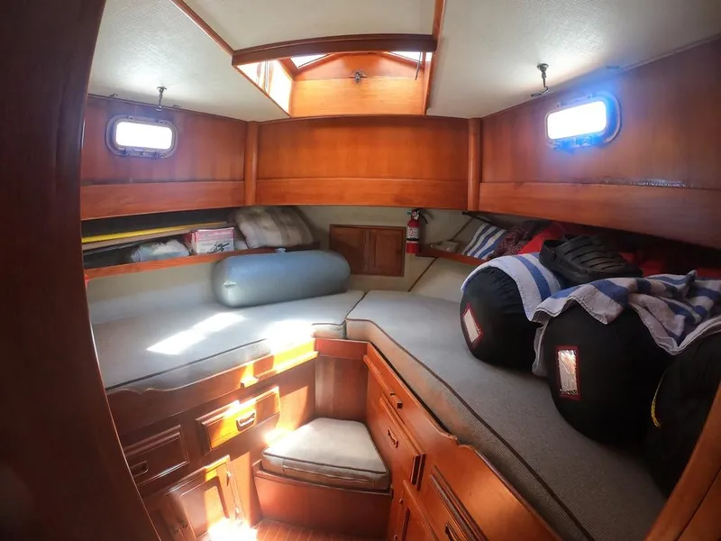 Slide: The Image of 1977 CHB 34 boat interior cabin with wooden finish and cozy seating. - 36