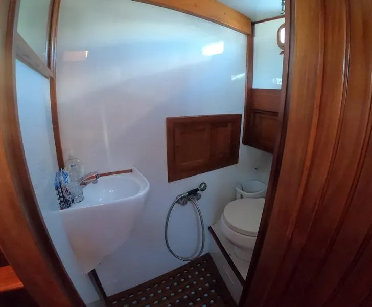 Slide: The Image of 1977 CHB 34 boat bathroom with sink, toilet, and wooden accents. - 38