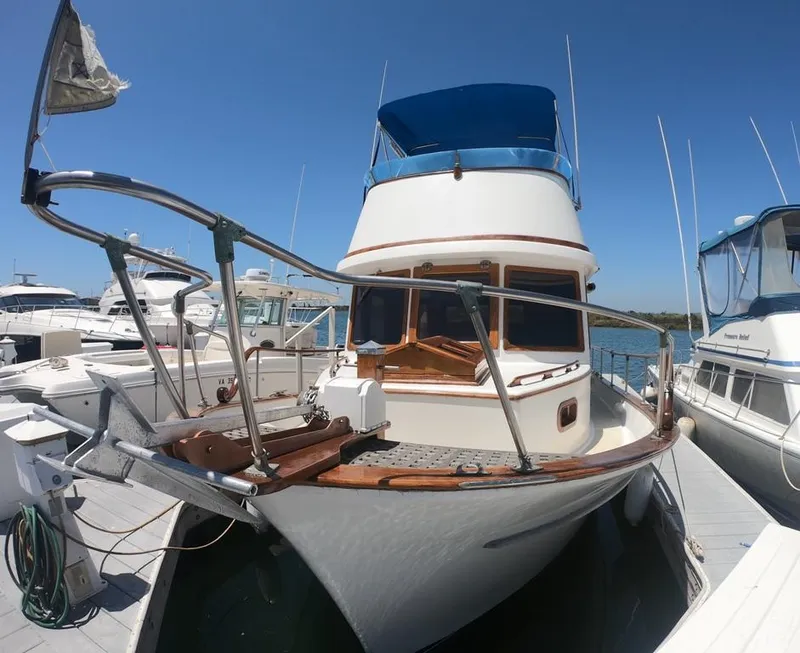 Slide: The Image of 1977 CHB 34 yacht docked at a marina on a sunny day. - 39