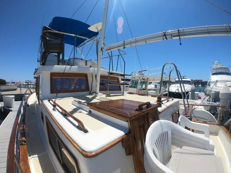 Slide: The Image of 1977 CHB 34 yacht docked at marina under clear blue sky. - 40