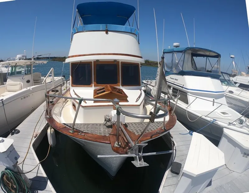 Slide: The Image of 1977 CHB 34 boat docked at marina, front view. - 41