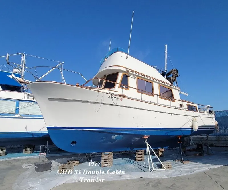 Slide: The Image of 1977 CHB 34 Double Cabin Trawler on dry dock, blue and white hull. - 42