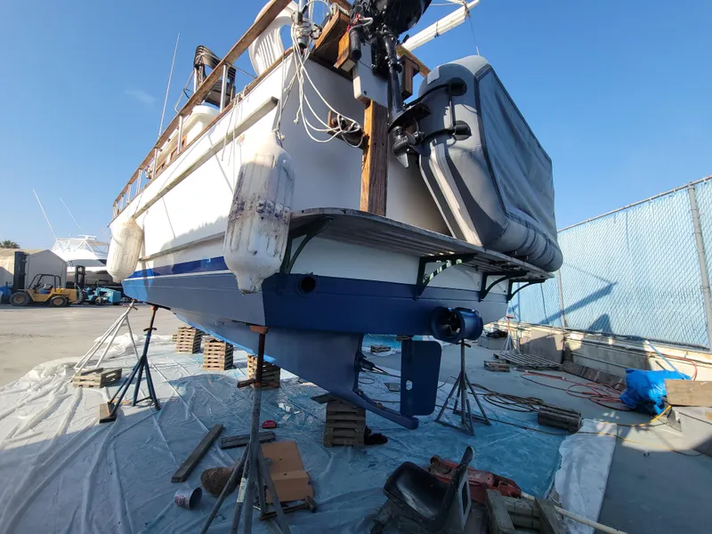 Slide: The Image of 1977 CHB 34 boat on dry dock, undergoing maintenance with visible hull and propeller. - 46