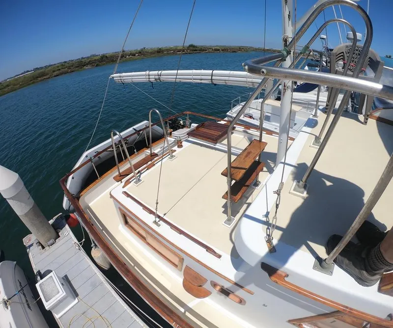 Slide: The Image of 1977 CHB 34 yacht docked at a marina, showcasing its deck and railing. - 9