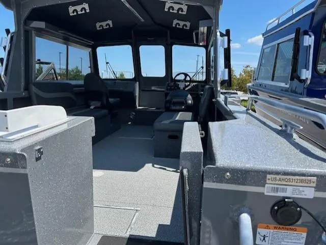 Slide: The Image of Interior of 2025 Spartan 220 Maximus Pro boat, showcasing seating and steering area. - 5