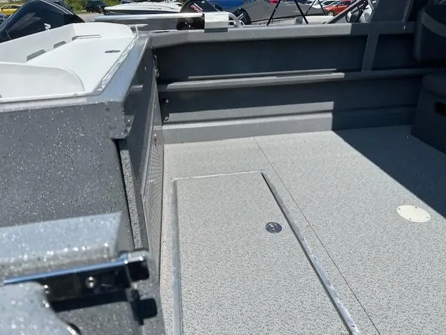 Slide: The Image of 2025 Spartan 220 Maximus Pro boat interior with spacious deck and storage compartment. - 7