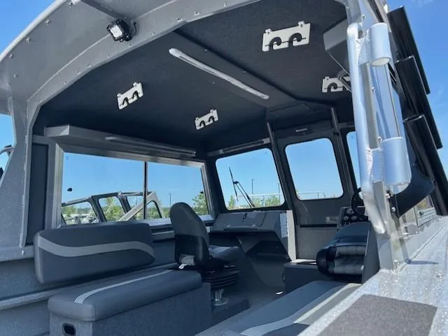 Slide: The Image of 2025 Spartan 220 Maximus Pro boat interior with modern seating and controls. - 8