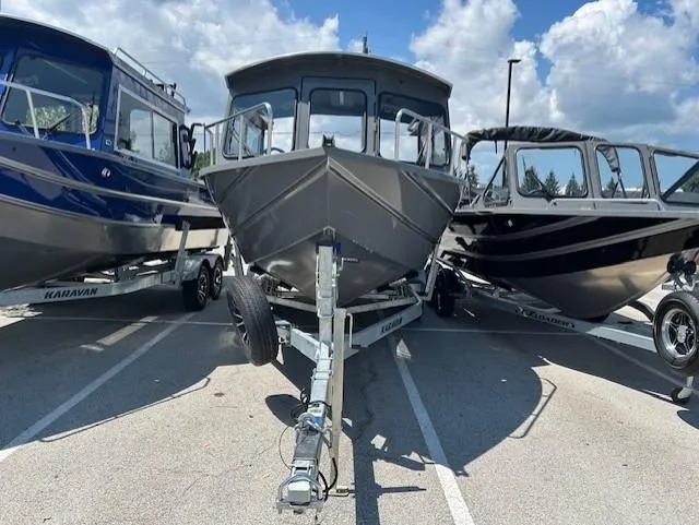 Slide: The Image of Three boats, including a 2025 Spartan 220 Maximus Pro, parked under a clear sky. - 9