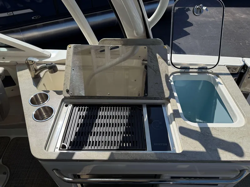 Slide: The Image of Outdoor kitchen area on 2017 Boston Whaler 320 Vantage boat with grill and sink. - 13