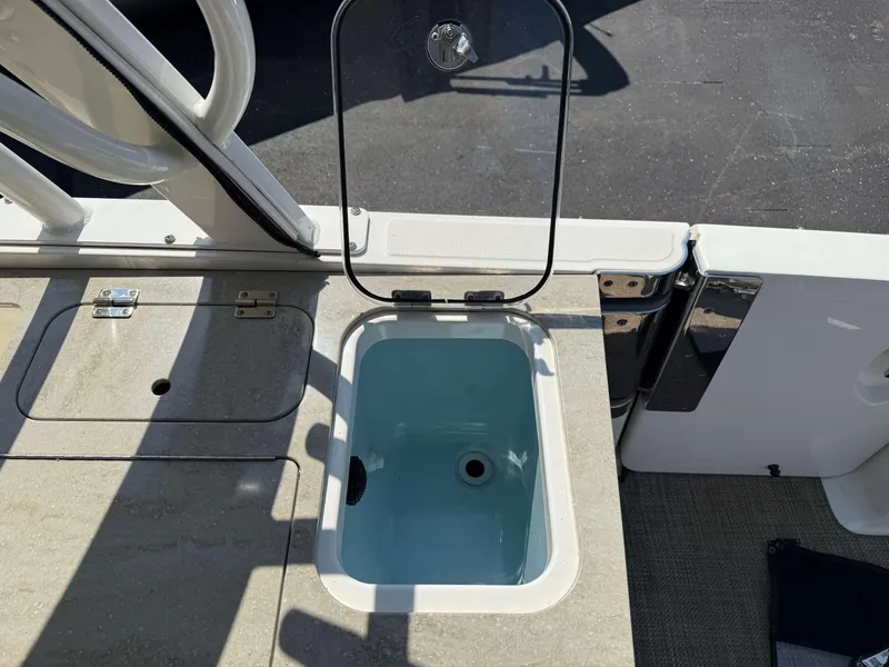 Slide: The Image of Open storage compartment on a 2017 Boston Whaler 320 Vantage boat deck. - 14