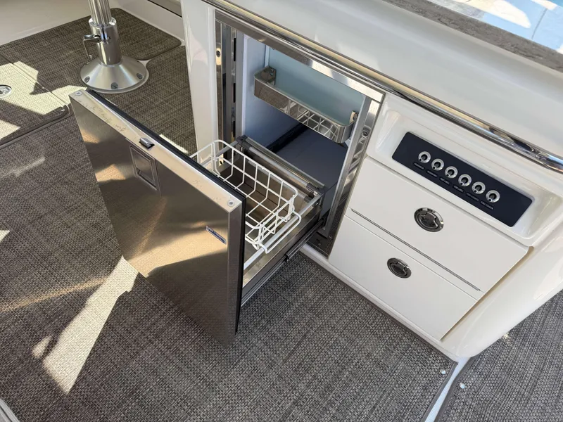 Slide: The Image of Open drawer refrigerator on 2017 Boston Whaler 320 Vantage boat interior. - 15
