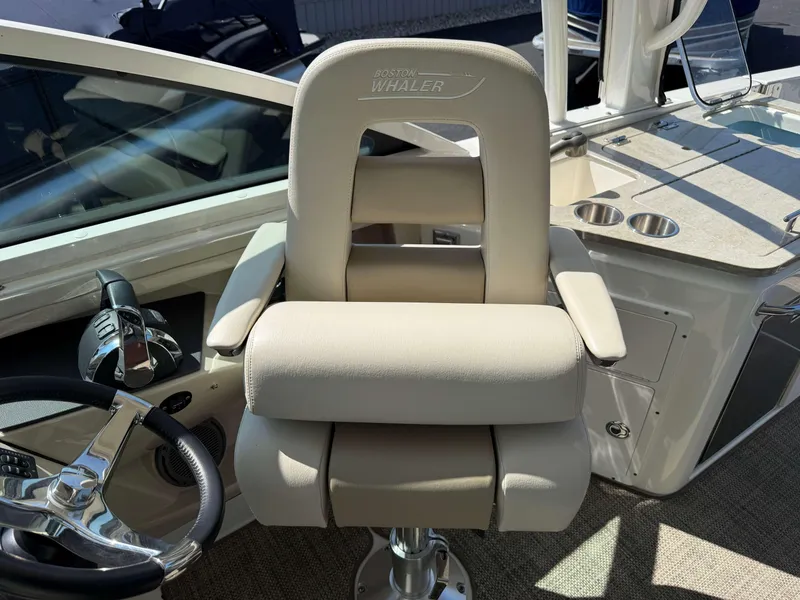 Slide: The Image of Captain's chair on 2017 Boston Whaler 320 Vantage boat, featuring helm and controls. - 24