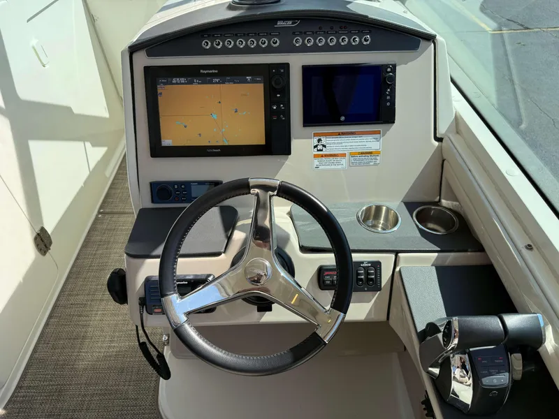 Slide: The Image of 2017 Boston Whaler 320 Vantage helm with dual displays and steering wheel. - 27