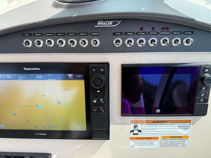 Slide: The Image of Control panel of a 2017 Boston Whaler 320 Vantage with navigation and display screens. - 28