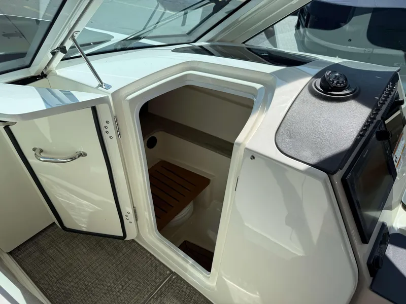 Slide: The Image of 2017 Boston Whaler 320 Vantage interior cabin with open door and navigation equipment. - 33