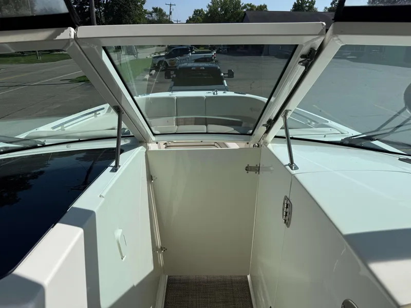 Slide: The Image of 2017 Boston Whaler 320 Vantage boat interior with open windshield and door. - 37