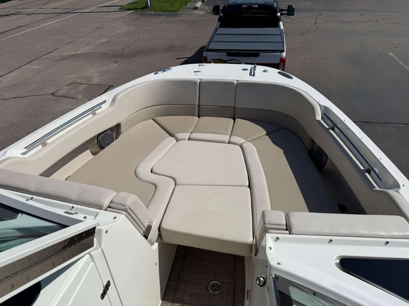 Slide: The Image of 2017 Boston Whaler 320 Vantage boat with spacious seating area, parked on a trailer. - 38