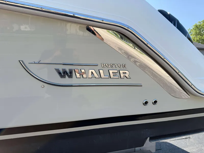 Slide: The Image of 2017 Boston Whaler 320 Vantage boat logo on sleek white hull. - 47
