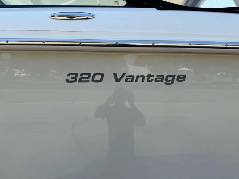 Slide: The Image of 2017 Boston Whaler 320 Vantage boat nameplate on hull. - 48