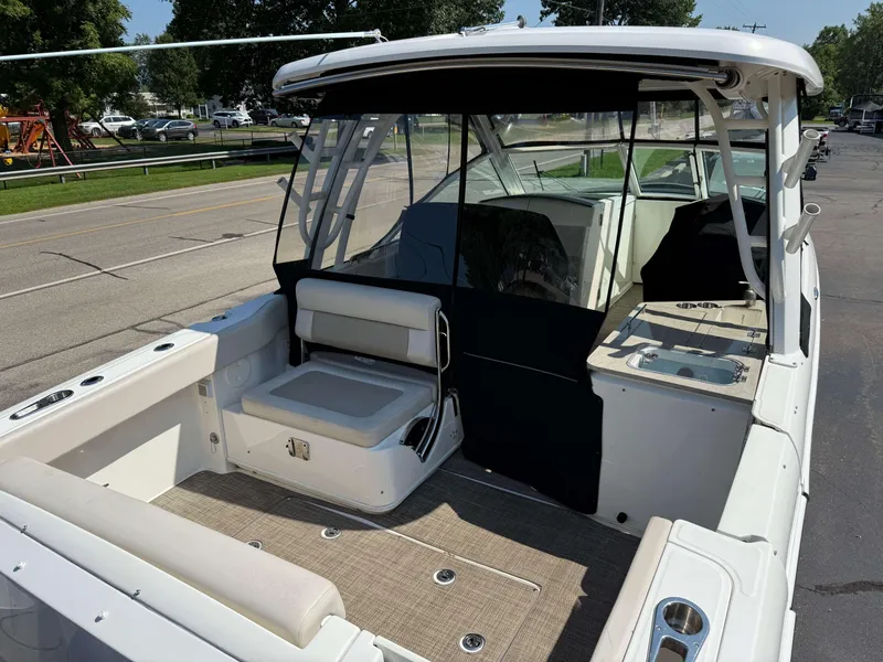 Slide: The Image of 2017 Boston Whaler 320 Vantage boat interior with seating and deck view. - 5