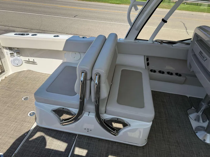 Slide: The Image of 2017 Boston Whaler 320 Vantage interior seating with beige upholstery and chrome accents. - 8