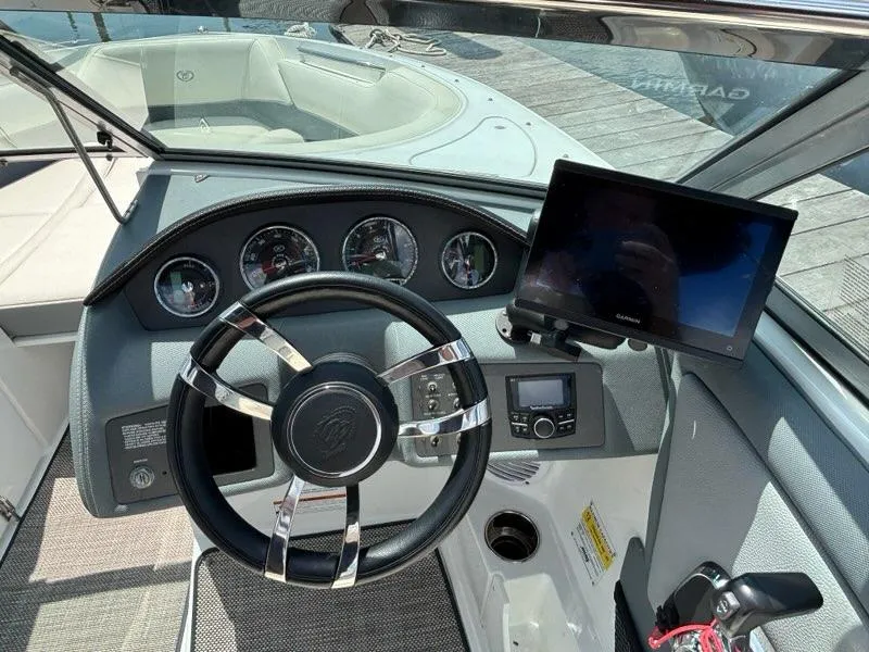 Slide: The Image of 2019 Cobalt 220S boat dashboard with steering wheel and Garmin display. - 13