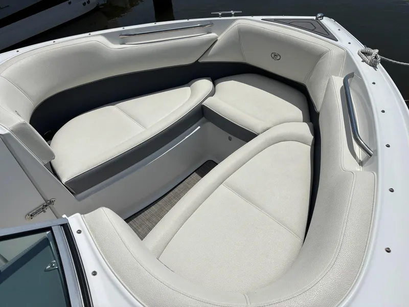 Slide: The Image of 2019 Cobalt 220S boat interior with white cushioned seating. - 16
