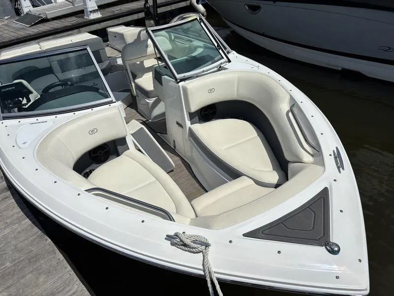 Slide: The Image of 2019 Cobalt 220S boat with white seating, docked at a marina. - 18