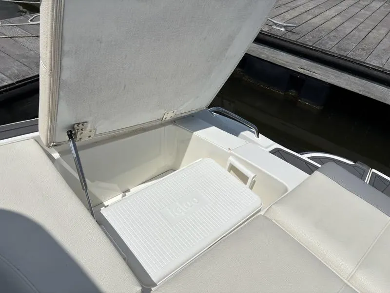 Slide: The Image of Open storage compartment on 2019 Cobalt 220S boat with Igloo cooler inside. - 25