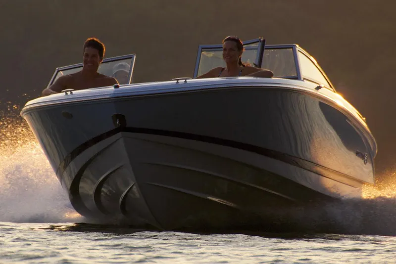 Slide: The Image of Manufacturer Provided Image: 2019 Cobalt 220S boat cruising on water at sunset. - 29