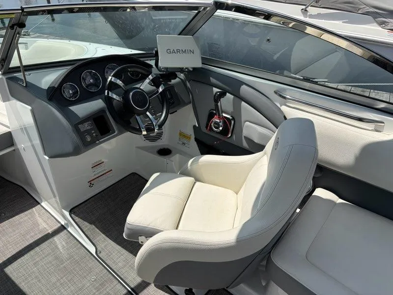 Slide: The Image of 2019 Cobalt 220S boat interior with Garmin navigation, steering wheel, and white seating. - 9
