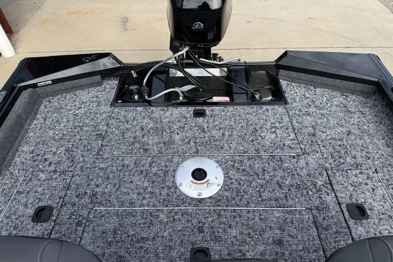 Slide: The Image of 2026 Tracker Pro Team 175 Crappie Edition boat interior with carpeted deck and motor. - 14