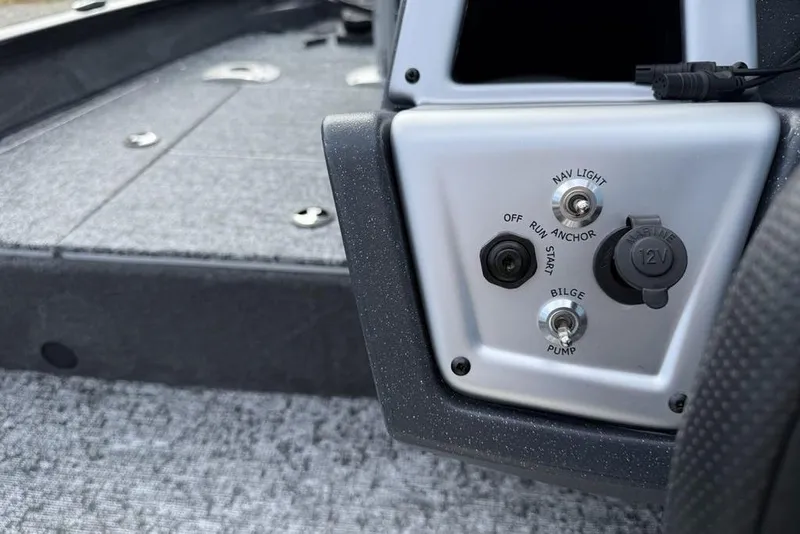 Slide: The Image of Control panel of 2026 Tracker Pro Team 175 Crappie Edition boat with switches and 12V outlet. - 16