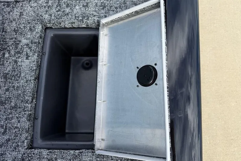 Slide: The Image of 2026 Tracker Pro Team 175 Crappie Edition boat storage compartment with open lid. - 18